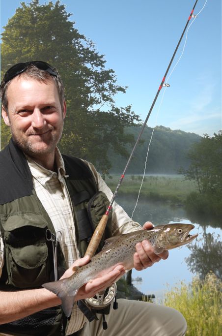 Angler zeigt einen Fisch in der Hand